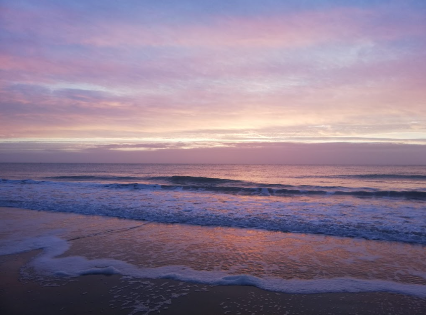 gentle ocean waves on a calm beach under a soft sky